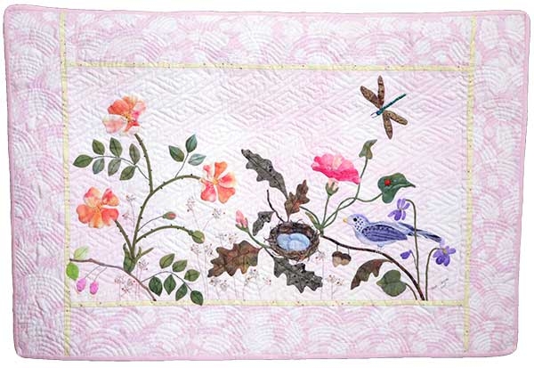Two patterns by Ellen Heck were combined to create this quilt. Hand applique and hand quilting.